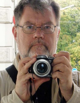 Mirror image of photographer John The Supercargo with camera